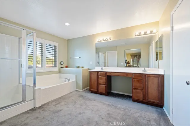 a bathroom with a bathtub toilet sink and mirror
