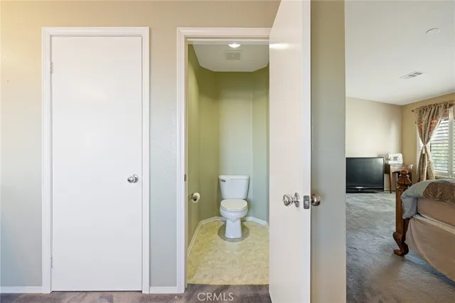 a view of walk in closet with clothes