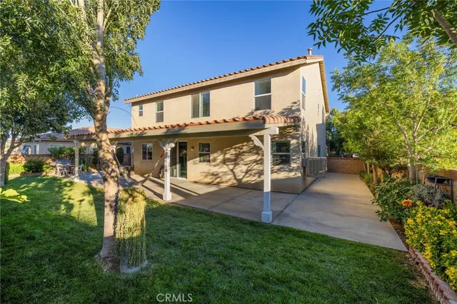 a view of deck with large trees and a yard