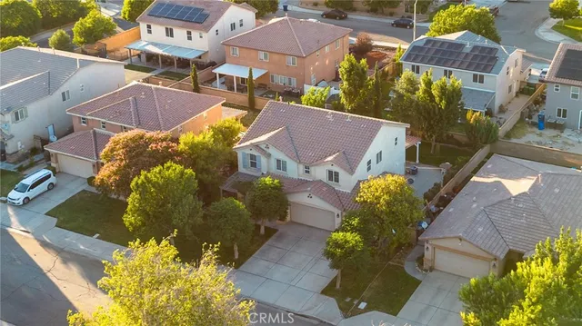 an aerial view of a house with a swimming pool