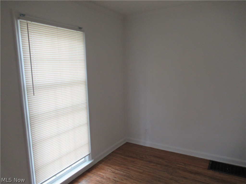 3824 East Antisdale Road Cleveland, OH 44118 - Photo 8 of 27 Interior room with wood-finish flooring, white baseboards, and a window featuring horizontal blinds