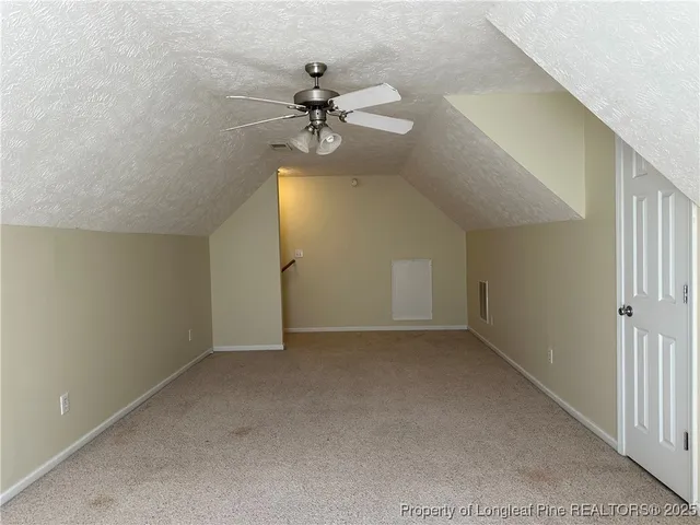 a view of a house with a wooden deck and a yard