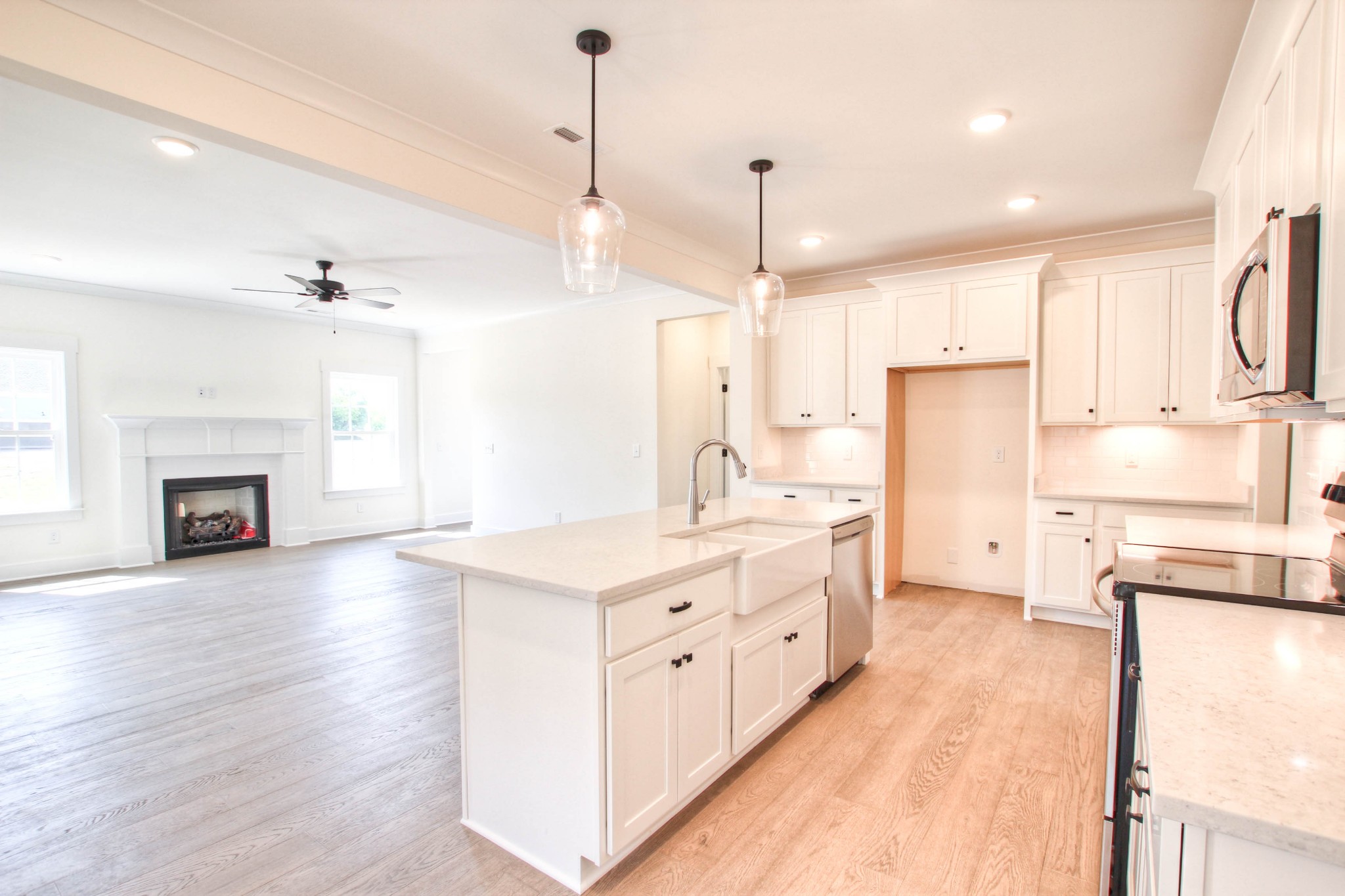 1533 Harrison Road Murfreesboro, TN 37128 - Photo 8 of 42 a large kitchen with kitchen island a stove a sink a center island and a wooden floor