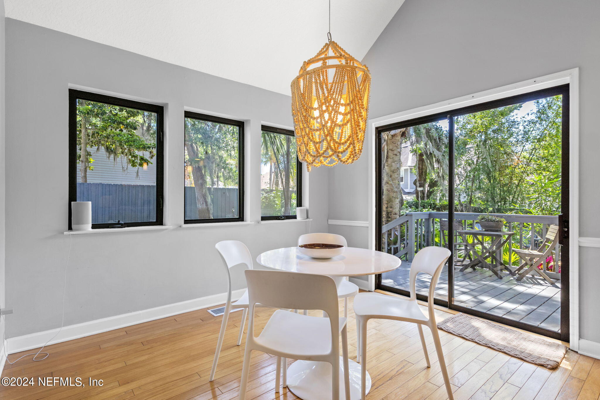 1350 Pinewood Road Jacksonville Beach, FL 32250 - Photo 14 of 55 a view of a dining room with furniture a chandelier and wooden floor