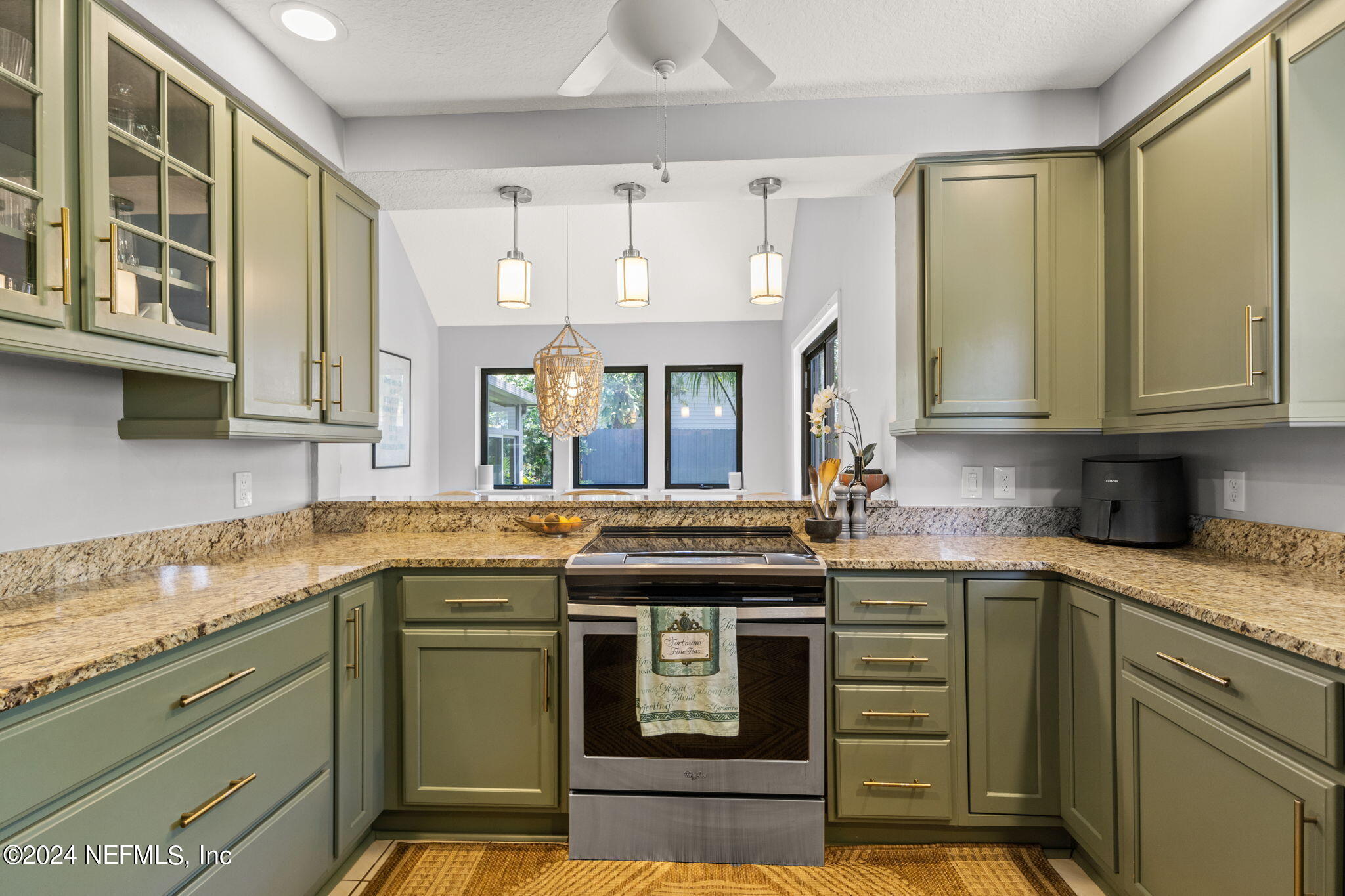 1350 Pinewood Road Jacksonville Beach, FL 32250 - Photo 17 of 55 a kitchen with stainless steel appliances granite countertop a stove and a sink