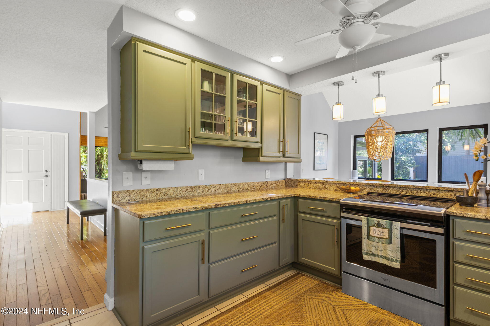 1350 Pinewood Road Jacksonville Beach, FL 32250 - Photo 18 of 55 a kitchen with stainless steel appliances granite countertop a sink and cabinets
