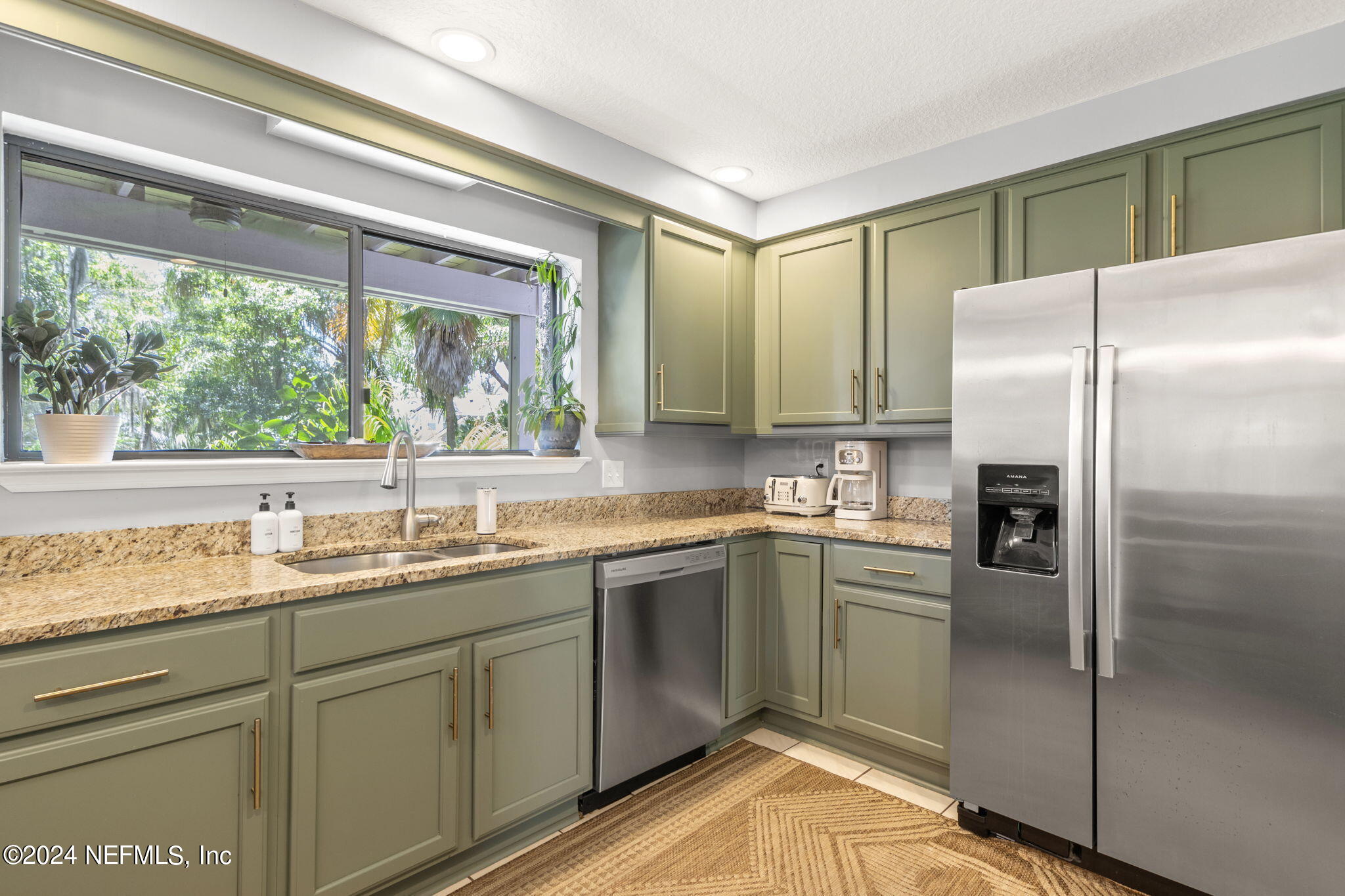 1350 Pinewood Road Jacksonville Beach, FL 32250 - Photo 19 of 55 a kitchen with a sink and refrigerator