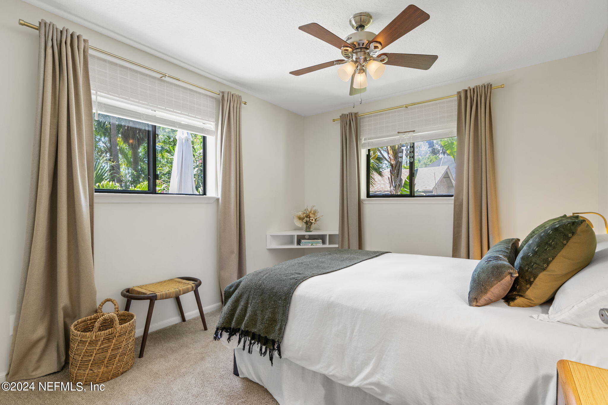 1350 Pinewood Road Jacksonville Beach, FL 32250 - Photo 28 of 55 a bedroom with a bed and a chandelier