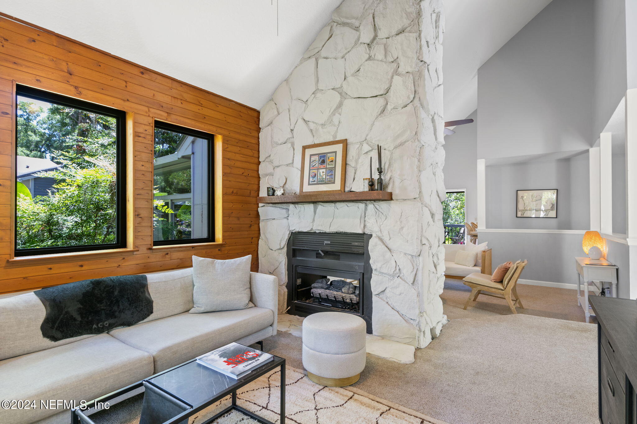 1350 Pinewood Road Jacksonville Beach, FL 32250 - Photo 4 of 55 a living room with furniture a fireplace and a large window