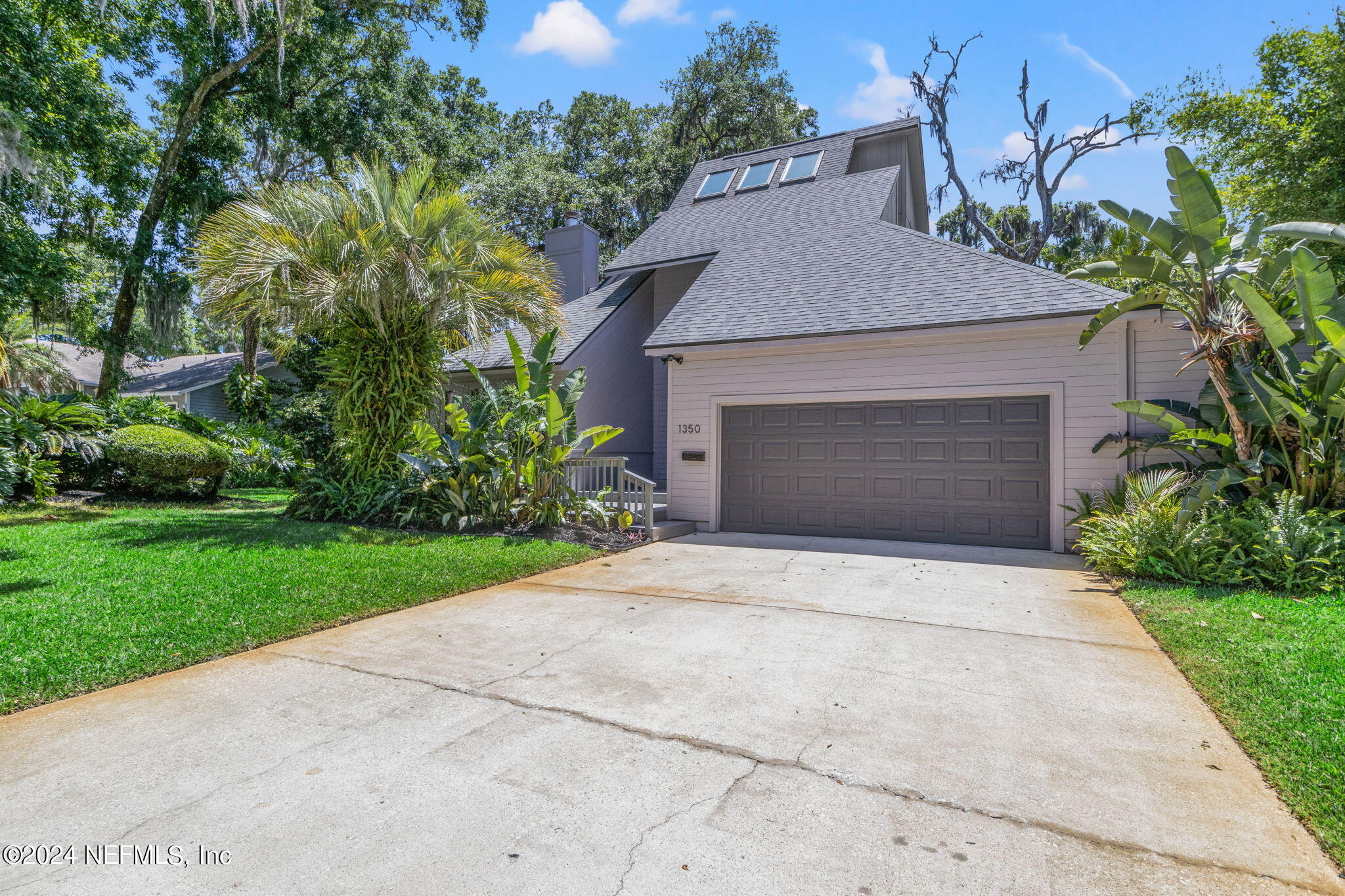 1350 Pinewood Road Jacksonville Beach, FL 32250 - Photo 54 of 55 a front view of a house with a yard and garage
