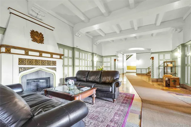 a living room with furniture fireplace and a large window