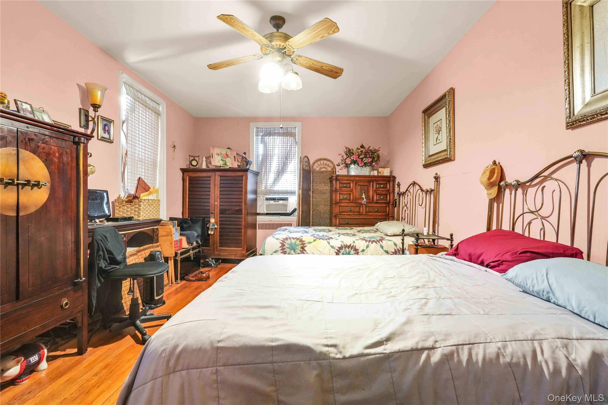 167-10 Crocheron Avenue, Unit 1F Queens, NY 11358 - Photo 5 of 16 a bed room with a bed and a chandelier