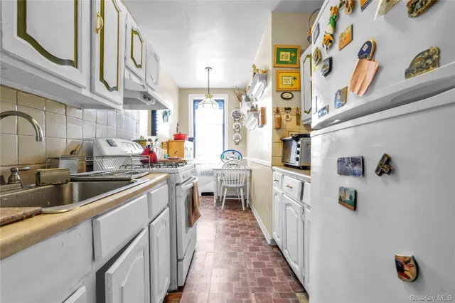 a kitchen with a sink and refrigerator