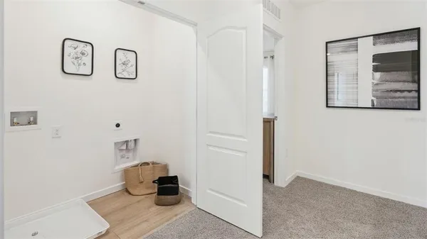 a hallway with a view of kitchen cabinetry