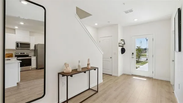 a view of a kitchen with furniture and wooden floor