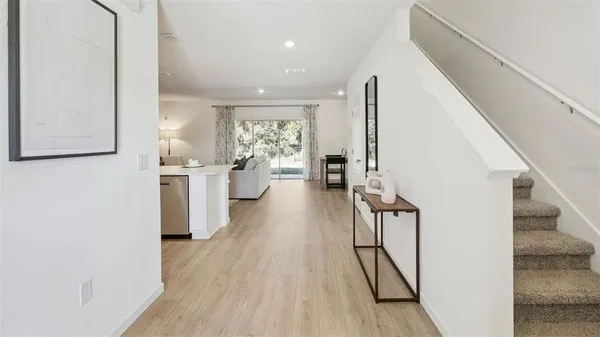a view of living room with furniture and wooden floor