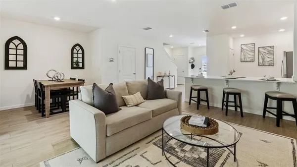 a living room with furniture kitchen view and a table