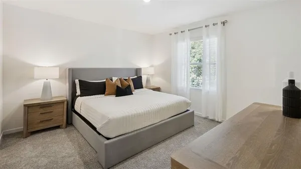 a bedroom with a bed and a television