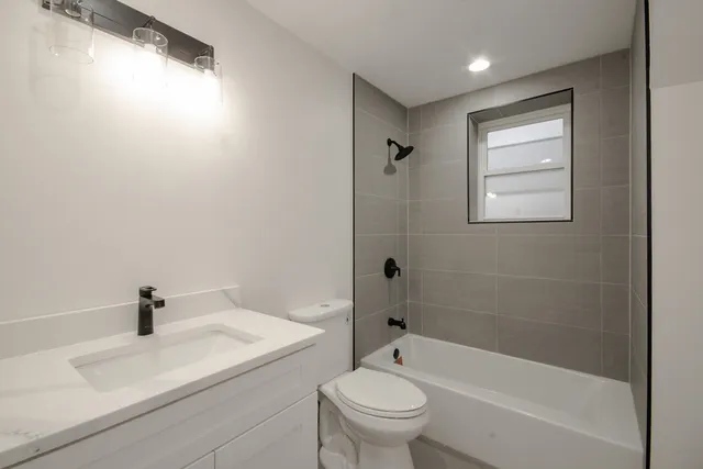 a bathroom with a sink toilet and bathtub