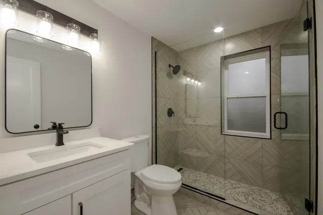 a bathroom with a sink toilet and shower