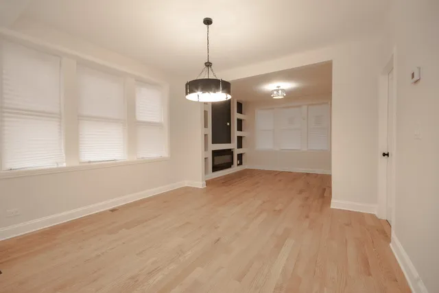a view of a room with a windows and wooden floor