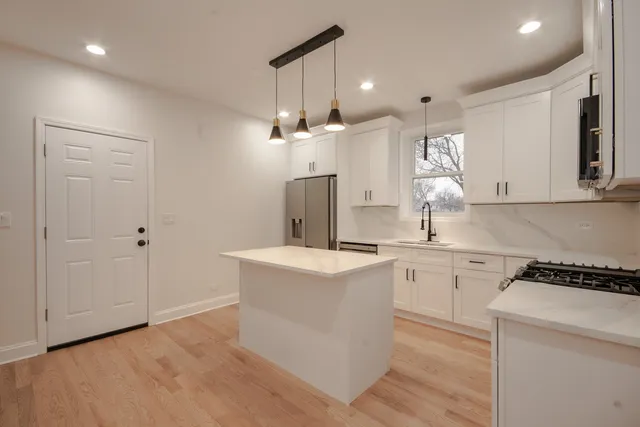 a kitchen with a sink a stove and cabinets