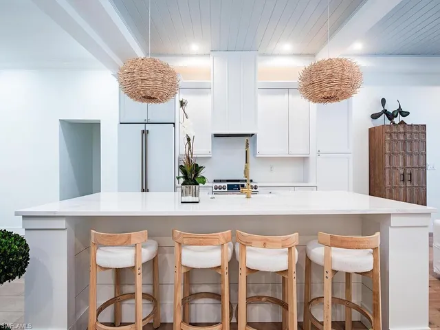 a kitchen with granite countertop a table and chairs