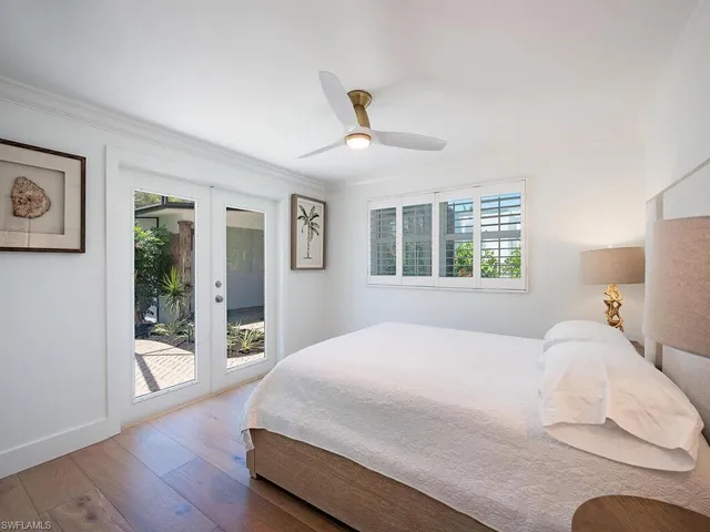a bedroom with a large bed and a window