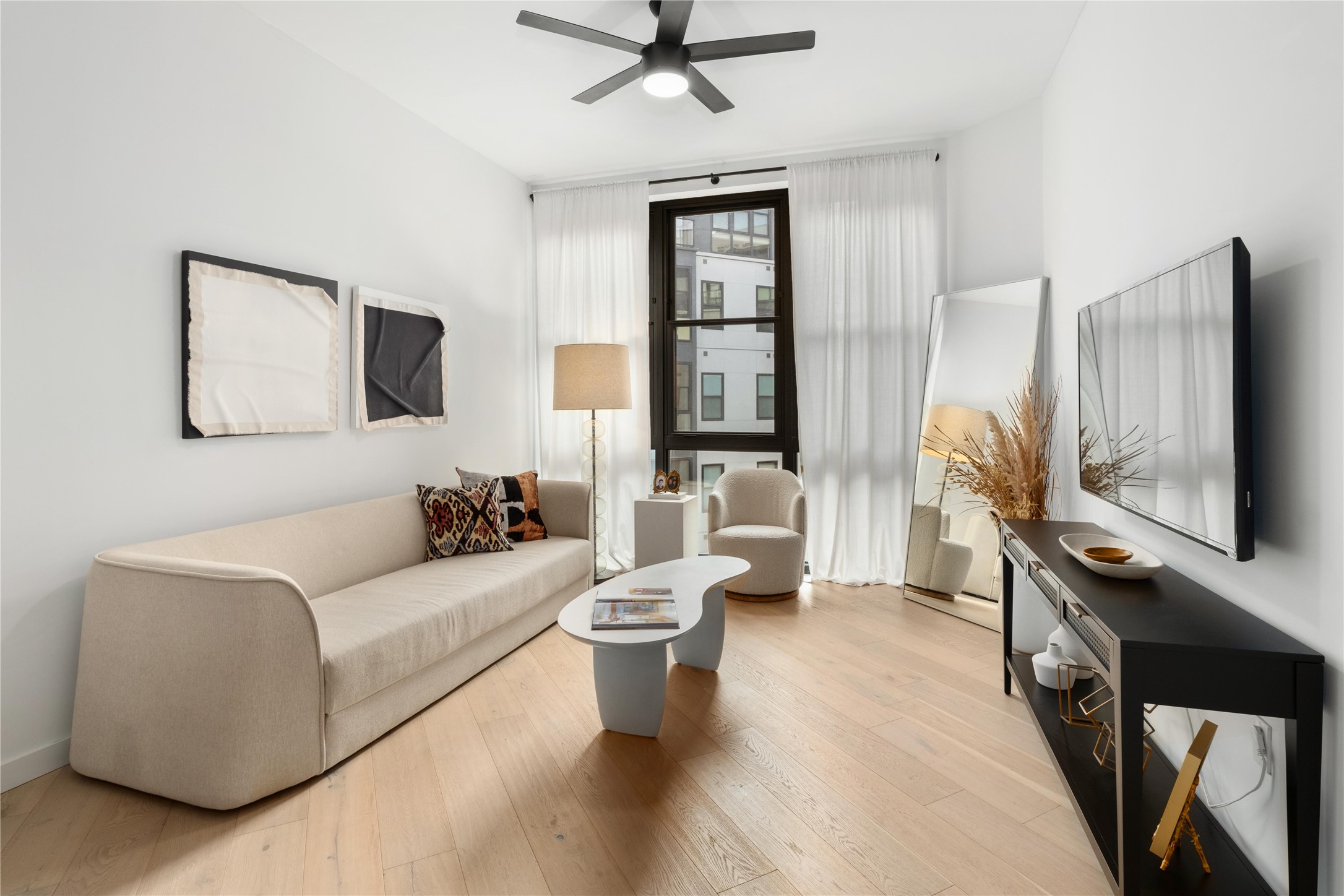 a living room with furniture and a flat screen tv