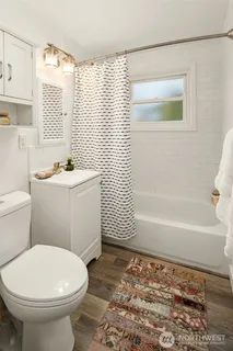 a bathroom with a sink a toilet and bathtub