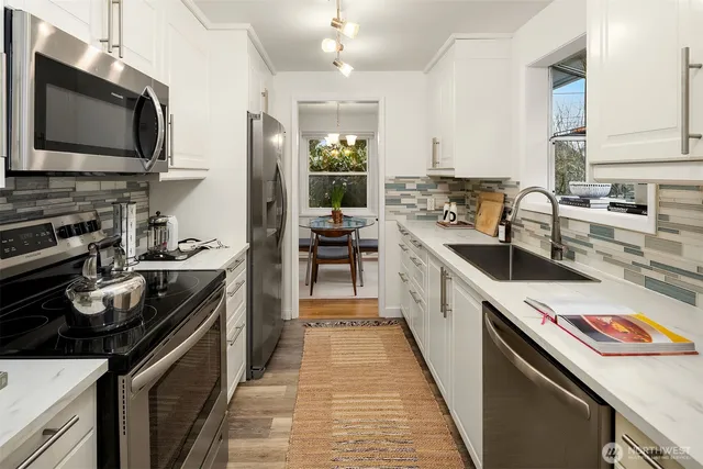 a kitchen with a sink stove and microwave