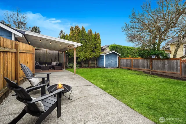 a view of a backyard with sitting area