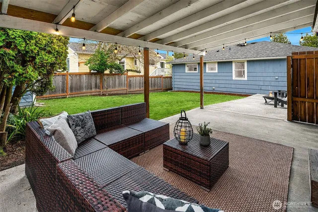 a view of a patio with a table chairs and a backyard