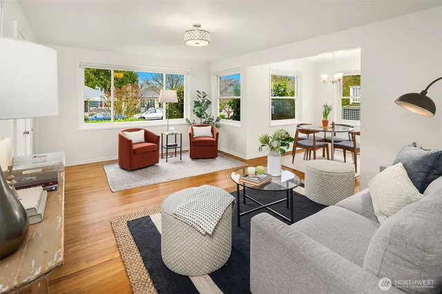 a living room with furniture fireplace and a large window