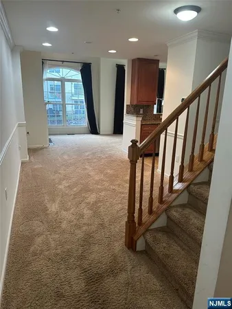 a view of an empty room with stairs