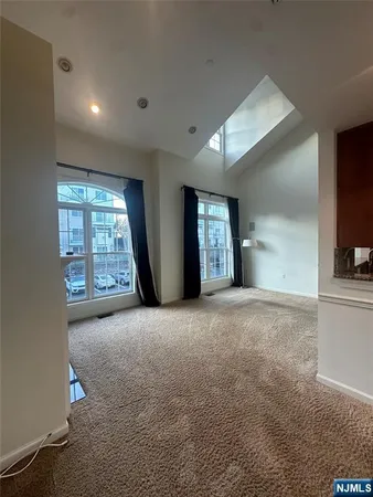 a view of empty room with windows and fireplace