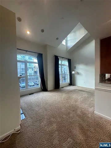 a view of empty room with windows and fireplace