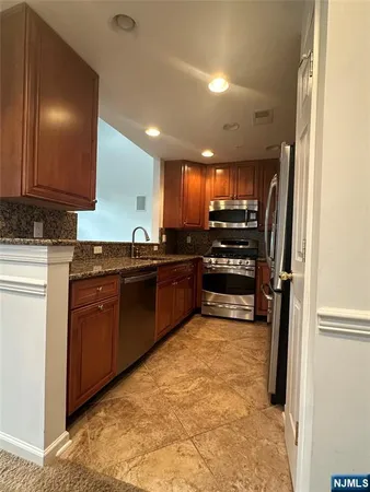a kitchen with wooden cabinets and a sink