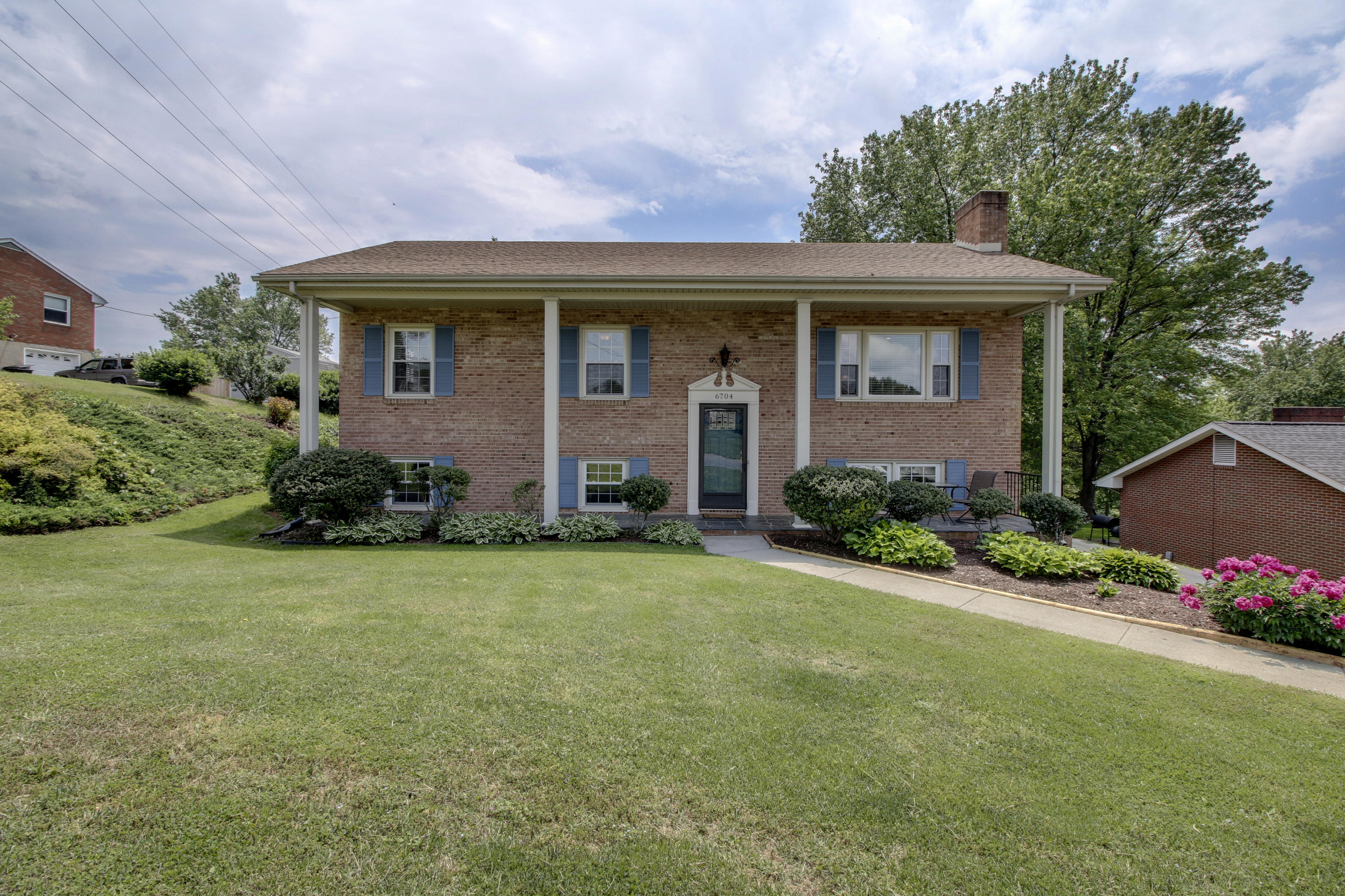 6704 Trevilian Road Roanoke, VA 24019 - Photo 3 of 46 a front view of a house with a yard