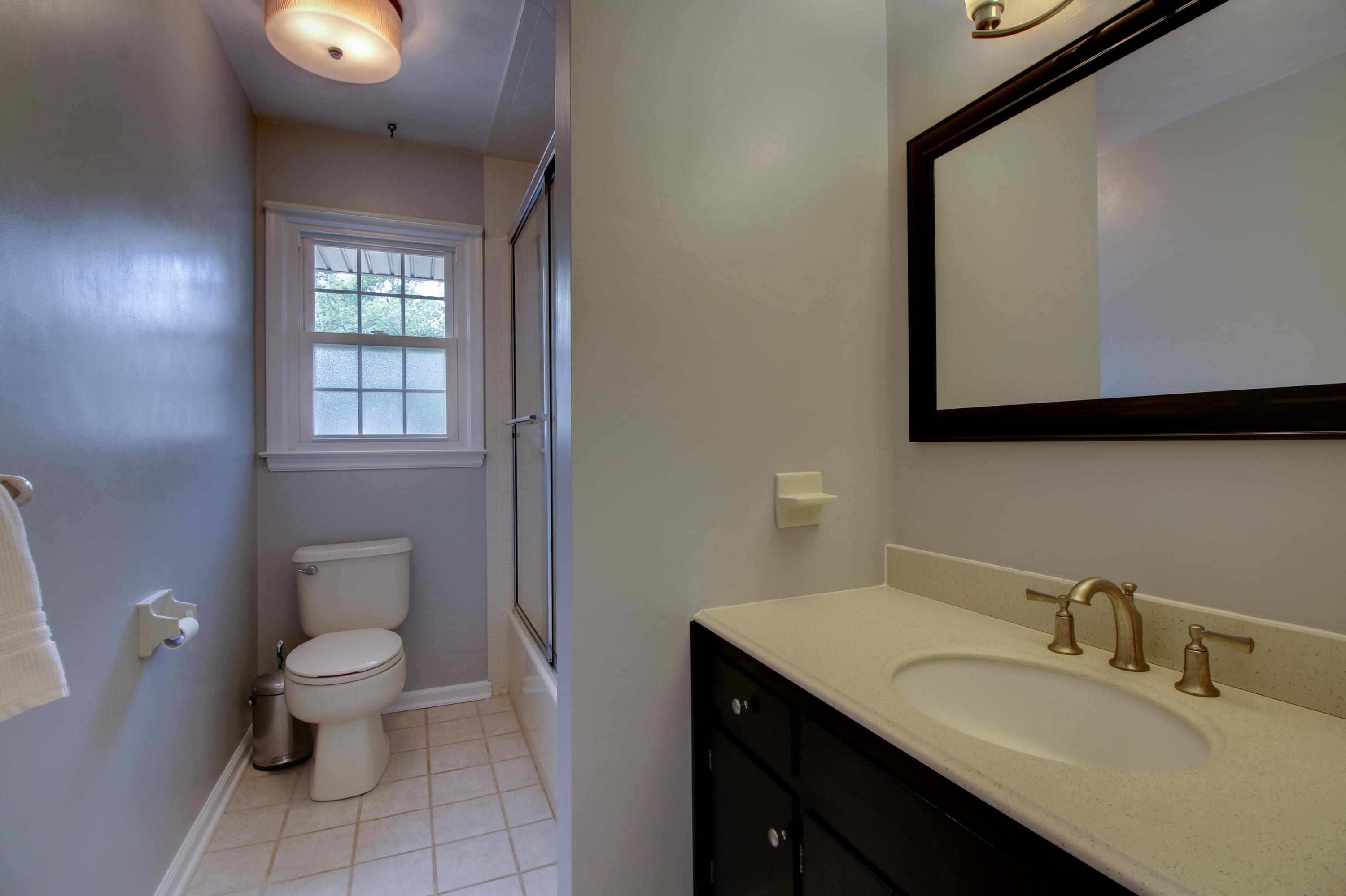 6704 Trevilian Road Roanoke, VA 24019 - Photo 26 of 46 a bathroom with a toilet sink and mirror