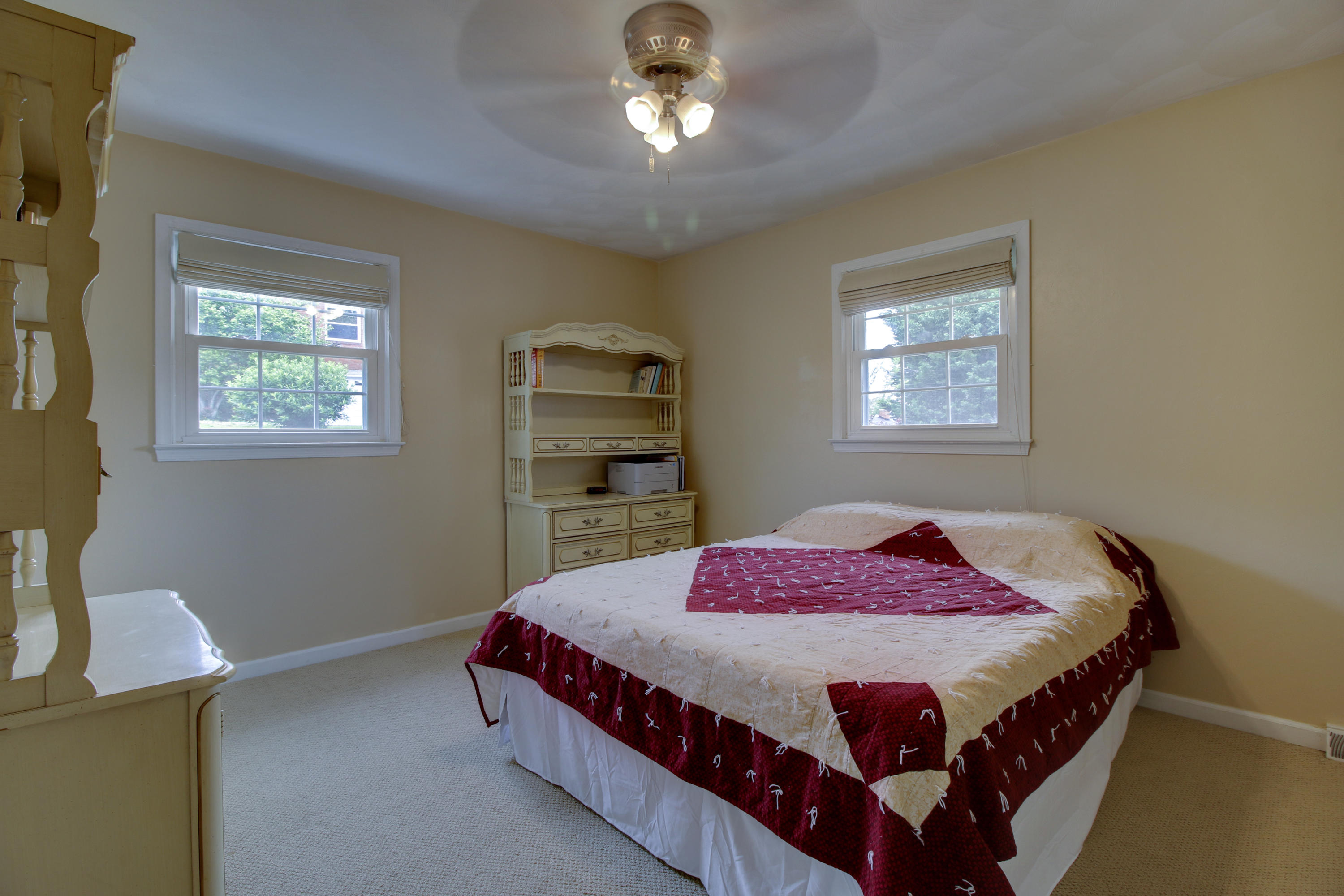 6704 Trevilian Road Roanoke, VA 24019 - Photo 27 of 46 a bedroom with a bed window and a chandelier