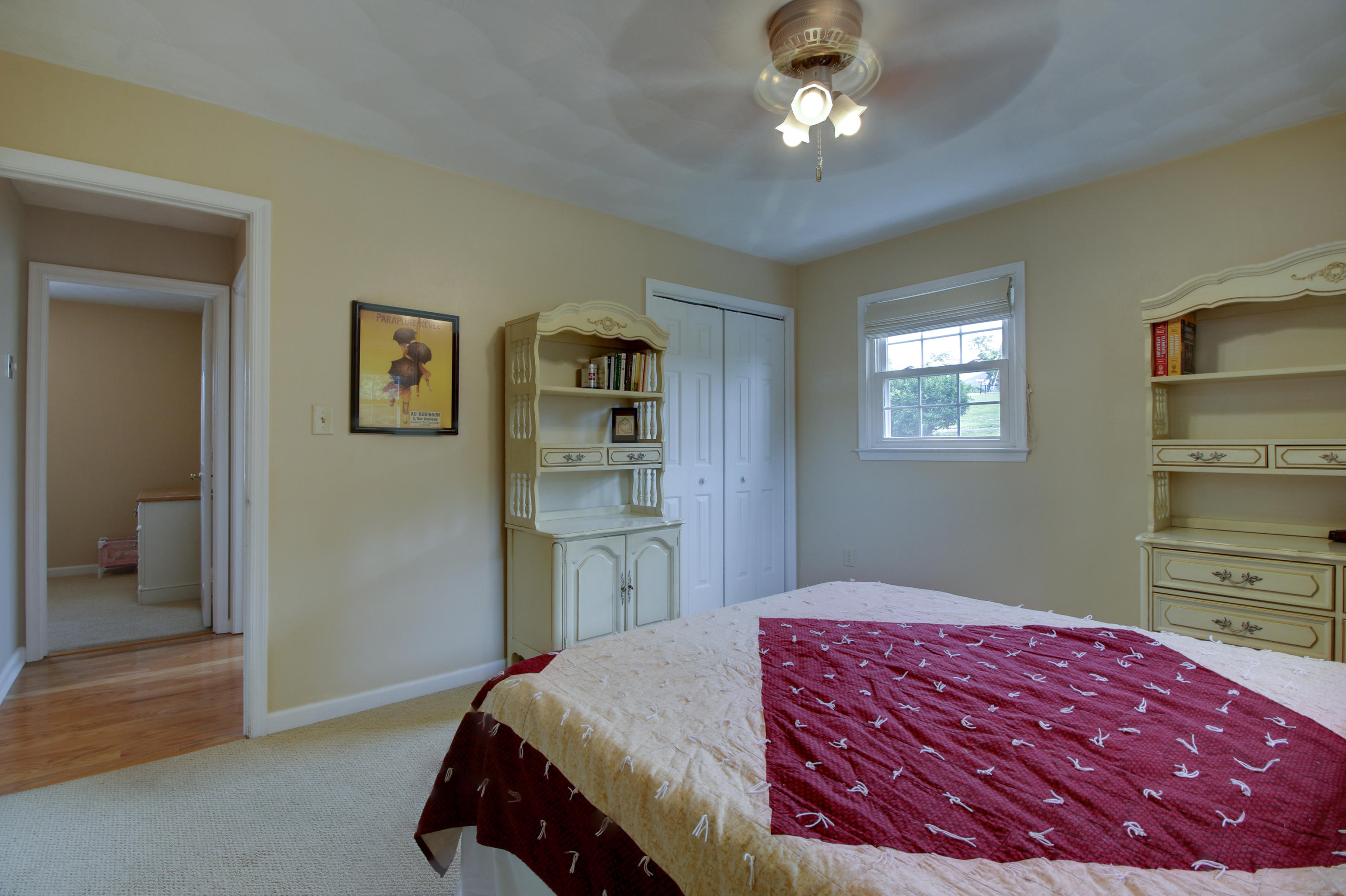 6704 Trevilian Road Roanoke, VA 24019 - Photo 28 of 46 a bedroom with a bed and a chandelier