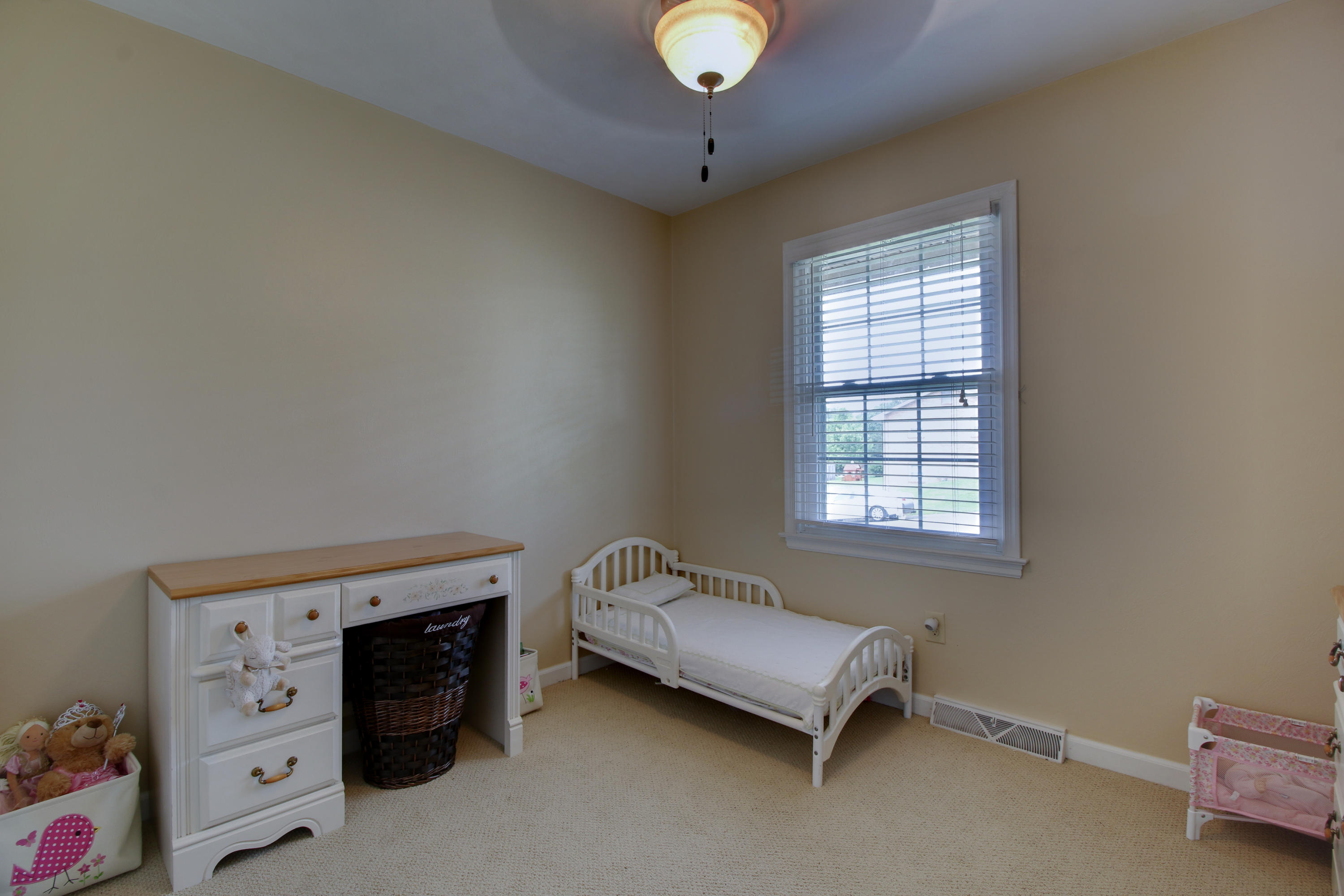 6704 Trevilian Road Roanoke, VA 24019 - Photo 30 of 46 a living room with a bed and a window