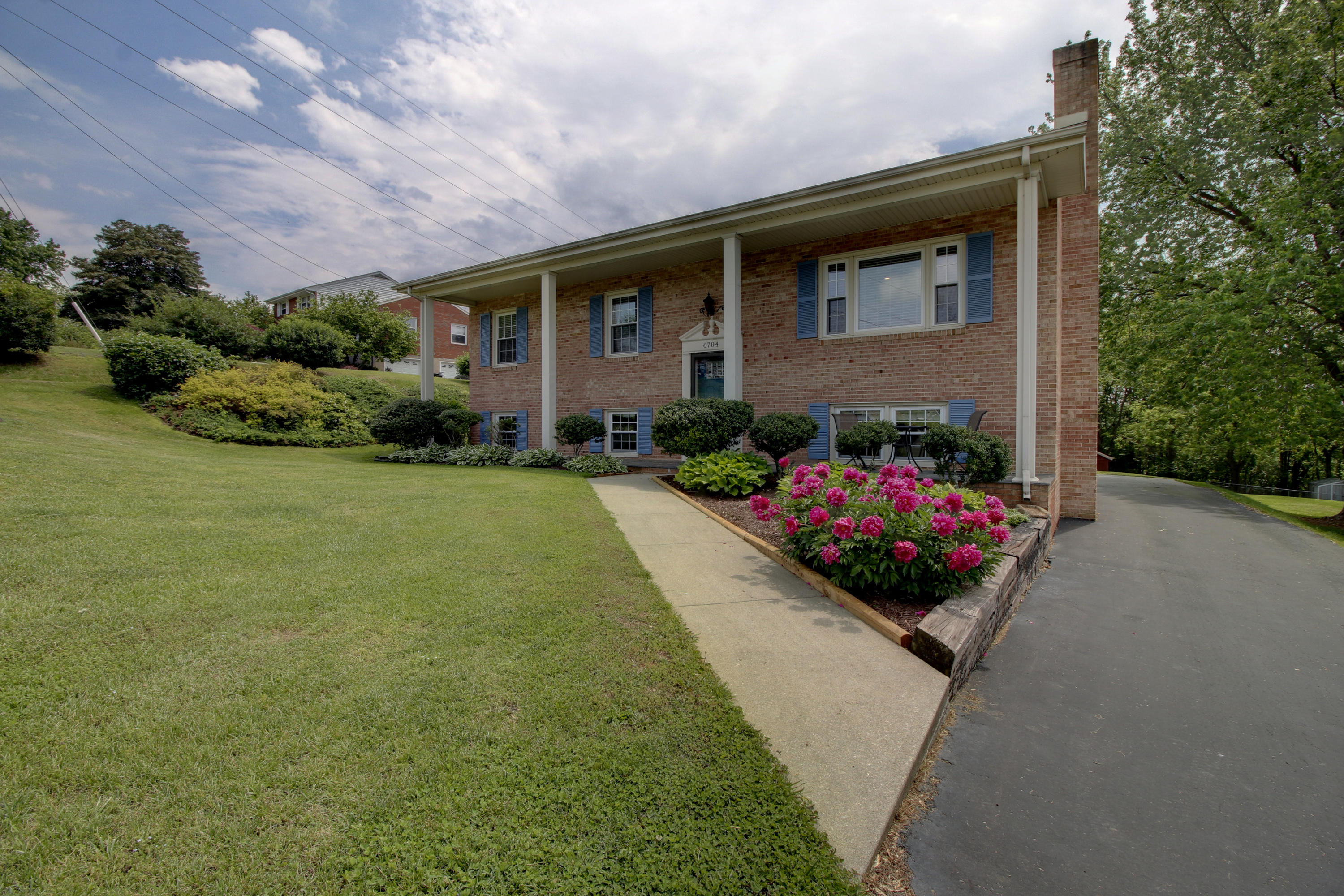 6704 Trevilian Road Roanoke, VA 24019 - Photo 4 of 46 a front view of a house with a yard