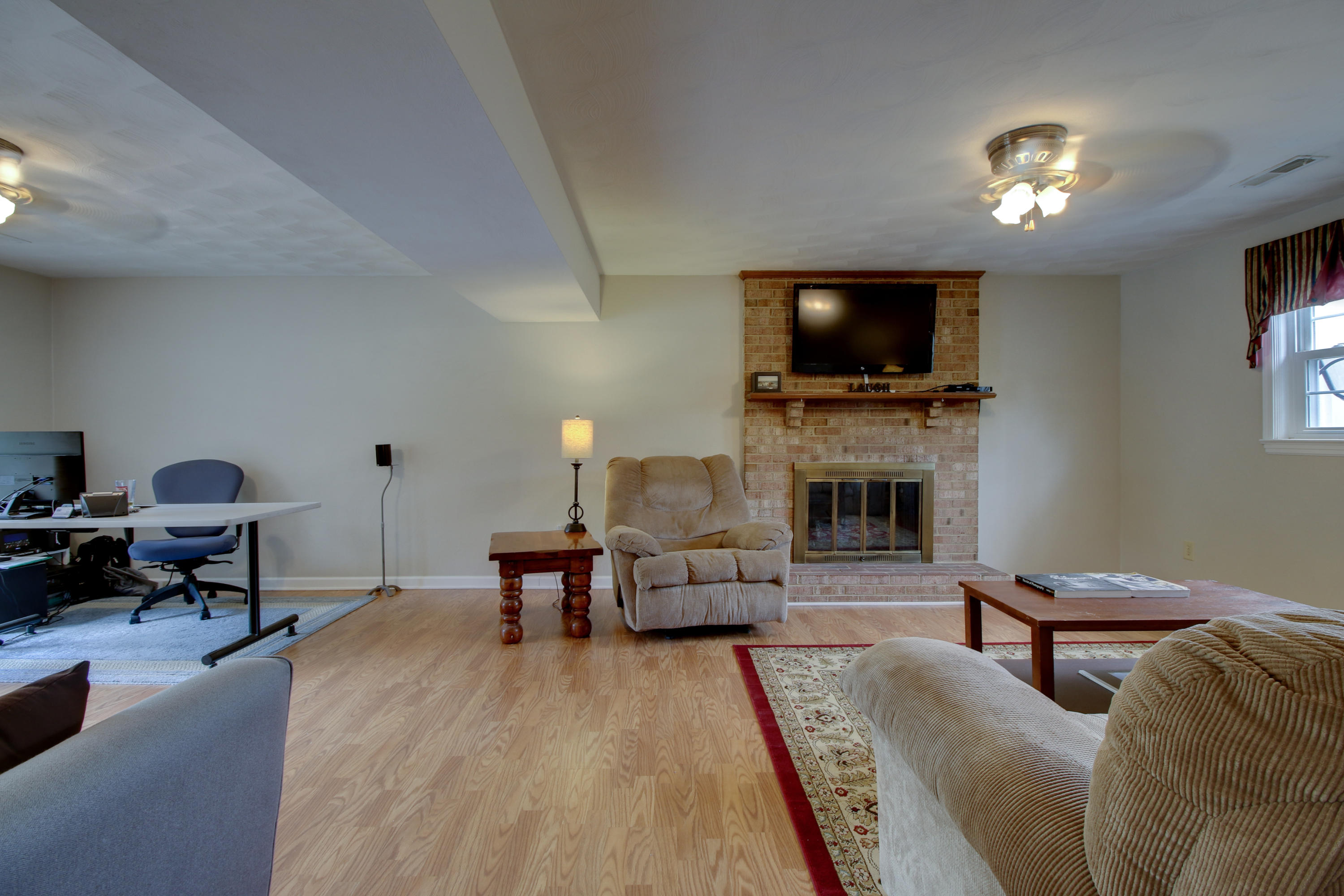 6704 Trevilian Road Roanoke, VA 24019 - Photo 31 of 46 a living room with furniture a flat screen tv and a fireplace