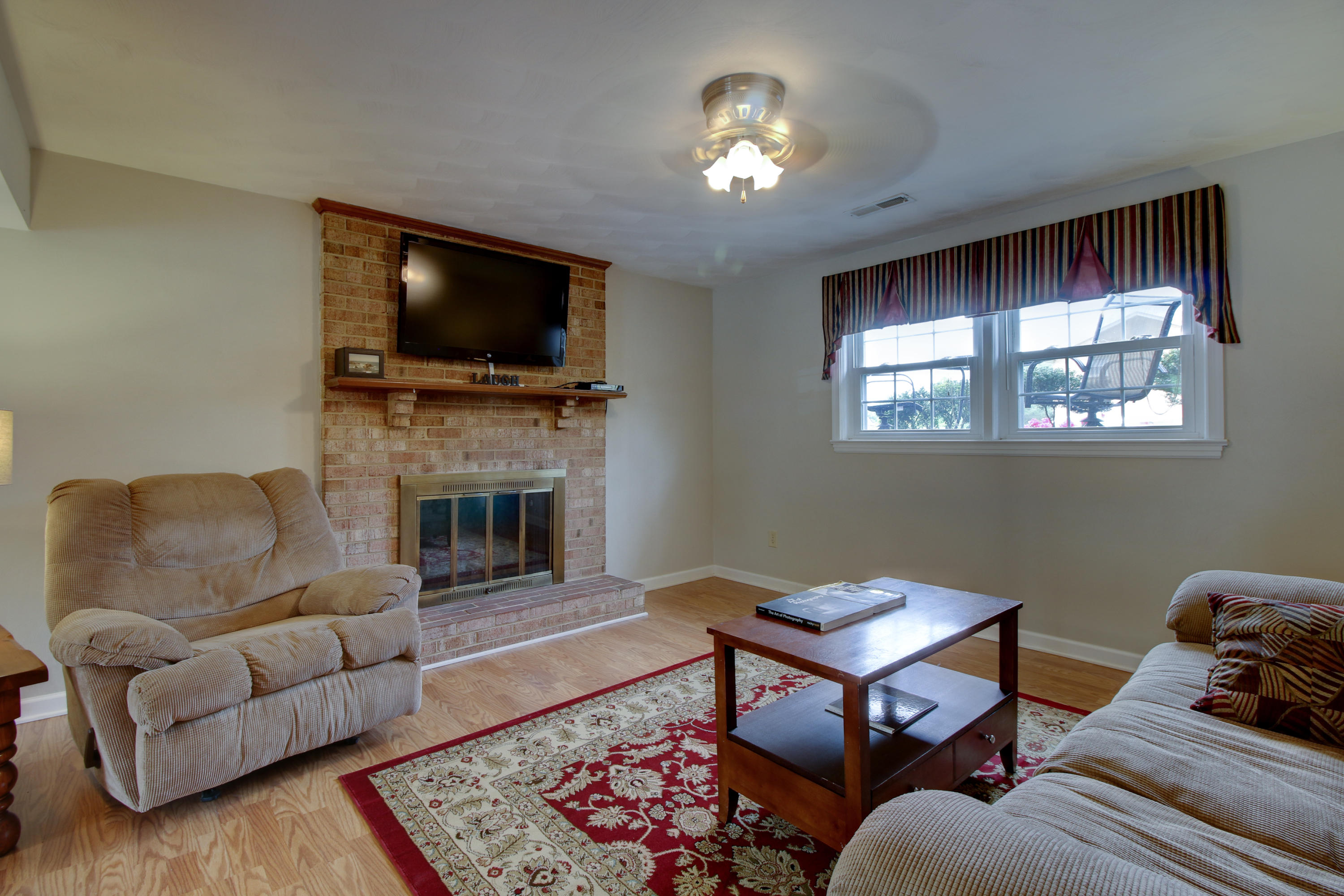 6704 Trevilian Road Roanoke, VA 24019 - Photo 32 of 46 a living room with furniture a flat screen tv and a fireplace