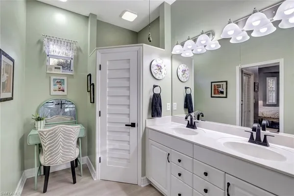 a bathroom with a sink a vanity and a mirror
