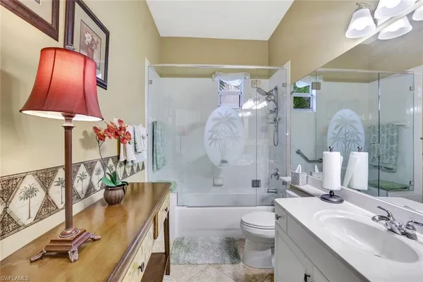 a bathroom with a sink tub and mirror