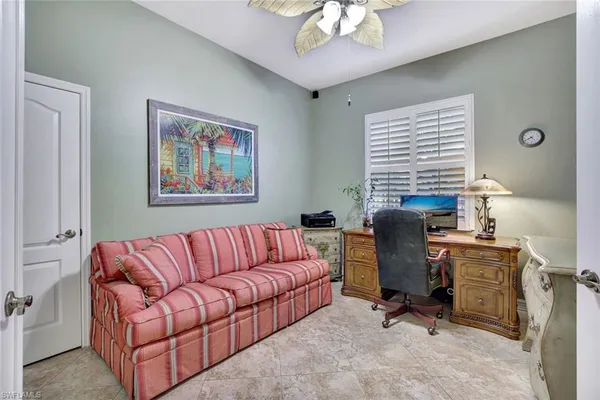 a view of a livingroom with workspace and a couch