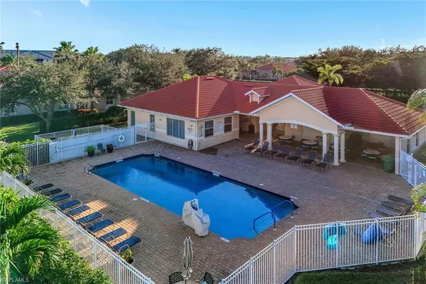 a aerial view of a house with pool and a yard